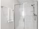 Clean, modern shower with a glass door and bench at 12833 Edsel Dr, Raleigh, NC 27613