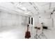 Soundproof studio with white walls and tile, featuring music equipment and ample space at 12833 Edsel Dr, Raleigh, NC 27613
