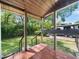 Covered back porch with view of the yard, RV parking and wooded perimeter at 1301 Lynnwood Rd, Knightdale, NC 27545