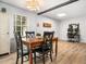 Dining area features wood floors and modern light fixtures, leading to office at 1301 Lynnwood Rd, Knightdale, NC 27545