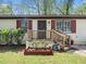 Close-up of the entrance with a small wooden porch and charming decorative touches at 1301 Lynnwood Rd, Knightdale, NC 27545