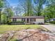 Cozy single-story home featuring red shutters and a well-manicured lawn at 1301 Lynnwood Rd, Knightdale, NC 27545