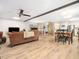 Open-concept living and dining area with hardwood floors, and modern ceiling fan at 1301 Lynnwood Rd, Knightdale, NC 27545