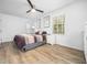 Bright main bedroom features hardwood floors, ceiling fan, and modern décor at 1301 Lynnwood Rd, Knightdale, NC 27545