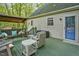 Inviting back deck featuring a cozy swing, comfortable seating, and a serene outdoor ambiance at 13816 N Meadows Ct, Wake Forest, NC 27587