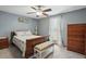 Comfortable bedroom with ceiling fan, natural light, and neutral colors at 13816 N Meadows Ct, Wake Forest, NC 27587