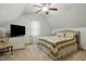 Attic bedroom features a ceiling fan and comfortable furnishings at 13816 N Meadows Ct, Wake Forest, NC 27587
