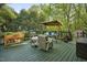 Spacious backyard deck features a comfortable swing and seating at 13816 N Meadows Ct, Wake Forest, NC 27587