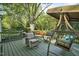Spacious backyard deck features comfortable seating and a swing at 13816 N Meadows Ct, Wake Forest, NC 27587