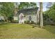 View of home featuring tidy landscaping, side bench, and American Flag at 13816 N Meadows Ct, Wake Forest, NC 27587