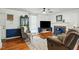 Living room with a fireplace, hardwood floors, and comfortable seating at 13816 N Meadows Ct, Wake Forest, NC 27587