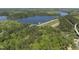 An aerial view of a lake with green forested areas, a dam, and parking areas near the property at 1401 Freshwater Ct, Wake Forest, NC 27587