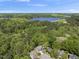 Expansive aerial view of the property showcasing the lush green surroundings and the serene lake at 1401 Freshwater Ct, Wake Forest, NC 27587