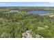 Scenic aerial view showcasing the property nestled within a community and near a lush wooded area and lake at 1401 Freshwater Ct, Wake Forest, NC 27587