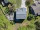 Aerial view of a home with a patio, firepit, and meticulously landscaped yard, nestled among lush greenery at 1401 Freshwater Ct, Wake Forest, NC 27587
