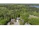 Aerial view of a home surrounded by lush trees, near a lake, showcasing its peaceful natural setting at 1401 Freshwater Ct, Wake Forest, NC 27587