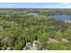 Aerial view of the property showcasing lush green surroundings and proximity to the lake and dam at 1401 Freshwater Ct, Wake Forest, NC 27587