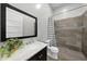 Bathroom with a modern vanity, framed mirror, toilet, and a walk-in shower with chevron shower curtain at 1401 Freshwater Ct, Wake Forest, NC 27587