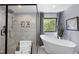 Bright bathroom featuring soaking tub, large glass shower and view of surrounding nature through a picture window at 1401 Freshwater Ct, Wake Forest, NC 27587