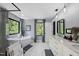 Bright bathroom with marble floors, soaking tub, glass enclosed shower and nature views through multiple windows at 1401 Freshwater Ct, Wake Forest, NC 27587