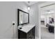 Bathroom featuring a dark vanity with a white sink and silver faucet at 1401 Freshwater Ct, Wake Forest, NC 27587