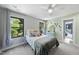 White bedroom with gray carpet and two windows at 1401 Freshwater Ct, Wake Forest, NC 27587