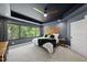Stylish bedroom with large windows providing natural light and views of surrounding nature at 1401 Freshwater Ct, Wake Forest, NC 27587