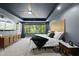Comfortable bedroom featuring tray ceilings, recessed lights, large windows, and stylish modern decor at 1401 Freshwater Ct, Wake Forest, NC 27587