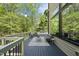 Inviting deck with outdoor seating, stylish rug, and wooded views, perfect for relaxing and entertaining at 1401 Freshwater Ct, Wake Forest, NC 27587