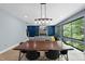 Spacious dining area with large windows, stylish light fixture, and open living space at 1401 Freshwater Ct, Wake Forest, NC 27587