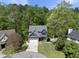 Stunning home exterior with a two-car garage, complemented by lush trees and an expansive green lawn at 1401 Freshwater Ct, Wake Forest, NC 27587