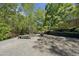 Outdoor firepit area with seating and gravel base, set in a wooded backyard for cozy gatherings at 1401 Freshwater Ct, Wake Forest, NC 27587