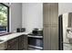 Kitchen area features stainless steel appliances, dark cabinetry, and a window overlooking the outside area at 1401 Freshwater Ct, Wake Forest, NC 27587