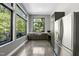 Kitchen featuring stainless steel appliances, dark cabinetry, a window overlooking the outside area, and concrete floors at 1401 Freshwater Ct, Wake Forest, NC 27587