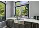 Kitchen area features a stainless steel sink, dark cabinets, and a large window overlooking the outside area at 1401 Freshwater Ct, Wake Forest, NC 27587