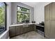 Kitchen featuring stainless steel appliances, dark cabinetry, a window overlooking the outside area, and concrete floors at 1401 Freshwater Ct, Wake Forest, NC 27587