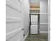 Efficient laundry space features a stackable washer/dryer and built-in shelving for convenient storage solutions at 1401 Freshwater Ct, Wake Forest, NC 27587