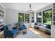 Bright living room featuring hardwood floors, custom built-ins, and large windows at 1401 Freshwater Ct, Wake Forest, NC 27587