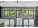 Open living room with large windows offering scenic views and natural light at 1401 Freshwater Ct, Wake Forest, NC 27587