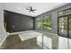 Bright living room with polished concrete floors, ceiling fan, and sliding glass door to the deck at 1401 Freshwater Ct, Wake Forest, NC 27587