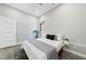 Bedroom with queen bed, ceiling fan, large window, polished concrete floors, and gray walls at 1401 Freshwater Ct, Wake Forest, NC 27587