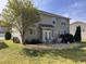 Backyard featuring a patio with outdoor seating, a well-maintained lawn, mature trees, and lush landscaping at 141 Steel Hopper Way, Garner, NC 27529