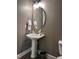A small bathroom with a pedestal sink and a toilet at 141 Steel Hopper Way, Garner, NC 27529