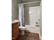 Bathroom featuring a tub with shower, toilet, vanity, and decorative accents at 141 Steel Hopper Way, Garner, NC 27529