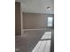 Expansive, carpeted room features large windows and neutral wall colors, bathed in sunlight at 141 Steel Hopper Way, Garner, NC 27529