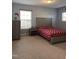 Bedroom featuring neutral carpet, a double window, and classic wood furniture at 141 Steel Hopper Way, Garner, NC 27529