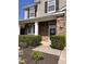 Welcoming home entrance features stone facade, inviting front door decor, manicured shrubs, and a cozy, covered entryway at 141 Steel Hopper Way, Garner, NC 27529