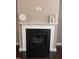 A fireplace with a white mantel and black tile at 141 Steel Hopper Way, Garner, NC 27529