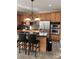 Bright kitchen featuring stainless steel appliances, granite island with seating, and ample wood cabinetry for storage at 141 Steel Hopper Way, Garner, NC 27529