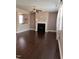 A living room with hardwood floors, a black fireplace, and a ceiling fan at 141 Steel Hopper Way, Garner, NC 27529
